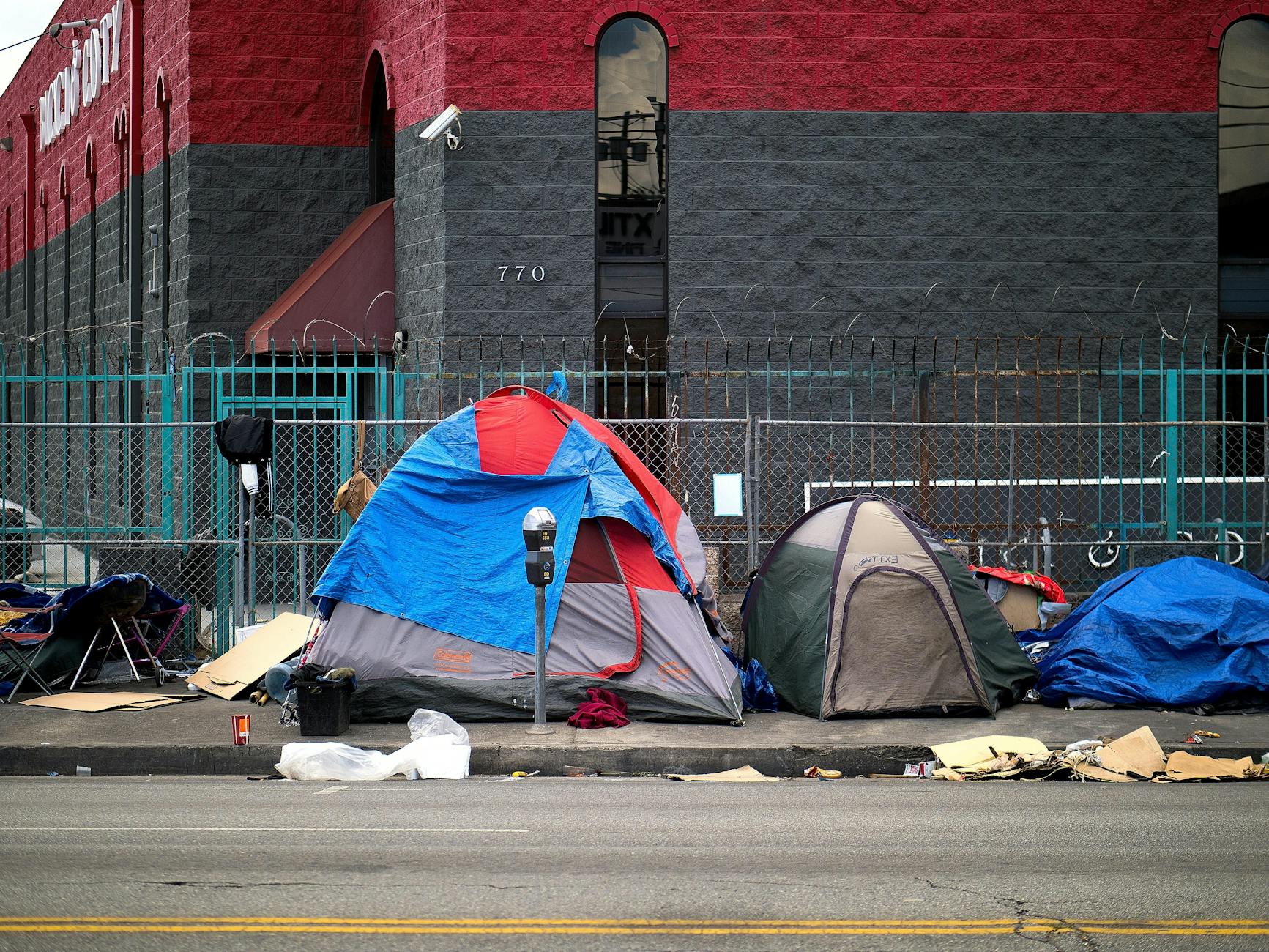 A view of tents set up on a sidewalk in Los Angeles, representing urban homelessness.